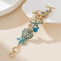 Golden starfish and seahorse charm bracelet with blue enamel and pearls for beach vacation - Bracelet