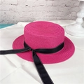 Detail of rose red straw boater hat featuring a black polka dot ribbon band trim - M (56-58cm) / Rose Red