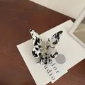 Elegant butterfly hair claw clip with black and white marble acetate pattern finish - Black & White