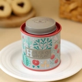 Floral round tin canister with double lid and red trim for tea or candy storage - Grey Plant