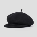 Detailed close-up of a black knitted newsboy cap showing fine texture and brim detail - M (56-58cm) / Black