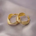 Elegant gold twisted hoop earrings with textured multi-strand design on purple silk - Multi-Layer Spiral Hoop / E-052---Gold