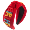 Detail of red knotted headband with colorful 'BRIGHT' hand-beaded lettering decoration - Red