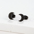 Detailed view of matte black stainless steel moon studs on a textured stone display - Moon / 002 Black Moon