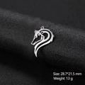 Macro shot of stylized stainless steel wolf head pendant on black fabric background - Stylized Wolf Head