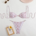 Detailed flat lay of a floral bikini with gold rings and elegant pearl embellishments - White with Red Floral