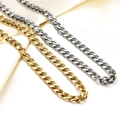 Close-up of gold and silver stainless steel Cuban link chains on beige fabric - Steel NK Curb Chain / 45cm+5cm