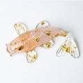 Pink crystal resin koi fish figurine with gold foil flakes on white surface - Rose Quartz
