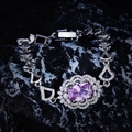 Detailed macro view of a luxury purple oval gemstone bracelet on a dark rock background - Pink Rhinestone Bracelet (16cm)