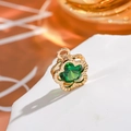 Macro shot of 14K gold-filled four-leaf clover pendant with a faceted green gemstone inlay - Flower - Emerald Green