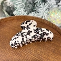 Detail of large black and white spotted acetate hair claw clip on wooden tray - Grape Pearl Jelly