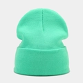 Detailed close-up showing the fine knit texture and mint green ribbing of the beanie - Neon Green
