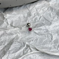 Macro view of pink heart-shaped zircon ear stud with silver screw ball back closure - Rose Red