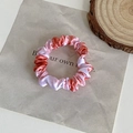 Elegant satin scrunchie with orange and pink marble pattern for hair styling - Gradient Red