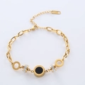 Elegante bracciale in acciaio dorato 18K con disco nero e ciondolo con pavé di cristalli - Oro