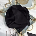 Macro shot of 100% mulberry silk scarf with glossy black finish and care label detail - 15x150cm / Black