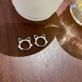 Detailed view of silver cat-shaped earrings on a wooden background with elegant reflections - Kitten Ear Buckle-Platinum Silver