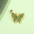Close-up of golden butterfly charm featuring green rhinestones for DIY jewelry making - Light Green Butterfly UV Gold Plated