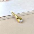 Detail view of a natural baroque freshwater pearl with a gold-plated bezel edge - Greyish White Baroque Pearl Pendant