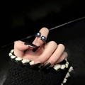 Adjustable black metal ring with dual blue galaxy stones worn on the index finger - Gun Black Ring
