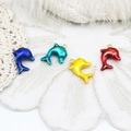 Macro shot of colorful enamel dolphin pendants with gold rings on white lace backdrop - Dolphin 16*19mm
