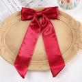 Large red satin bow hair clip with long ribbons on a vintage decorative display tray - Duckbill Hair Clips / Red