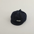 Detailed close-up of blue denim baby newsboy cap with white Hello embroidery and stitching - 50cm 1-4 Years / Black