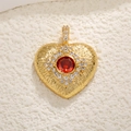 Gold heart pendant with red center stone and white zircon border on textured surface - Red Zirconia Gold Heart Charm / Red Zirconia Heart