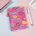 Pink coil notebook detail with pop-art slang icons and a decorative fuzzy pom-pom charm - Pink Pop Slogan