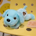Cute light blue plush dog doll resting on a yellow chair with colorful glowing features - Blue Embroidered Style