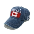 Close-up of Canada maple leaf embroidery and distressed denim fabric on baseball cap - Navy Blue