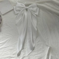 Elegant white satin oversized bow hair clip with flowing ribbon streamers for women - White