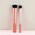Two-piece makeup brush set with coral orange handles and rose gold ferrule detail - Pink