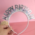 Close-up of Happy Birthday headband with silver glitter letters and rainbow laser fringe - Silver