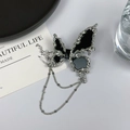 Anillo de mariposa en metal líquido con esmalte negro y cadenas de estrellas plata - Broche de Mariposa Negra con Borla