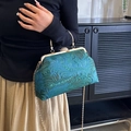 Elegant teal fabric kiss-lock handbag with peacock feather pattern and gold chain strap - Green