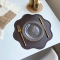 Dark brown floral faux leather placemat with beaded edge on a white dining table - Flower / Coffee