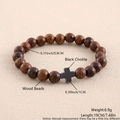 Detail view of 0.8cm wood beads and black hematite cross on this elastic bracelet - Wood Beads Black Cholite Cross 19cm