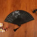 Classic black Chinese folding fan with white bamboo ink painting and elegant black tassel - Black Willow Catkins