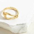 Detailed macro shot of 14K gold plated knot ring featuring an adjustable open band design - Knot Symbol Ring