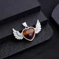 Tiger Eye heart pendant with silver angel wings and metallic bale on stone display - Tiger's Eye