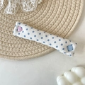 Detailed view of polka dot cable organizer strap with pink heart and blue round button - Blue Polka Dot