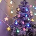 Colorful LED string lights with star and ball shapes hanging on a festive Christmas tree - Spheres + Stars (in Color) / 1.5m 10LED Battery