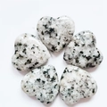 Five heart-shaped polished granite stones with grey and black mottled patterns - Sesame Jasper