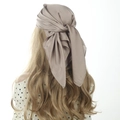 Elegant mocha gold satin square scarf worn as a minimalist head wrap for women - 70cm x 70cm / Camel
