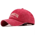 Macro detail of red washed cotton fabric and 3D 'ANGELESS' embroidery on baseball cap - Adjustable / Washed Red