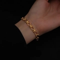 Fashionable gold layered chain bracelet with oval links and round bead accents on a wrist - E179 Hollow Ring Gold Bracelet