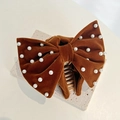 Detail of a brown velvet bow hair claw clip with delicate pearl beads on a stone surface - Velvet Pearl Bow / Brown