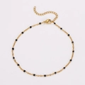 Detail of golden stainless steel anklet with black beads and lobster clasp closure - Black