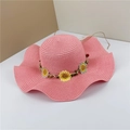 Detail of pink straw sun hat with sunflower embroidery and woven wavy brim texture - Pink